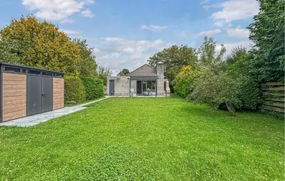 a large yard with a house with a garage at Nice Home In Dirkshorn With Wifi in Dirkshorn