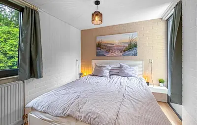 a bedroom with a bed with a painting on the wall at Nice Home In Dirkshorn With Wifi in Dirkshorn