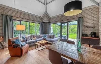 a living room with a couch and a table at Nice Home In Dirkshorn With Wifi in Dirkshorn