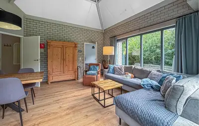 a living room with a couch and a table at Nice Home In Dirkshorn With Wifi in Dirkshorn