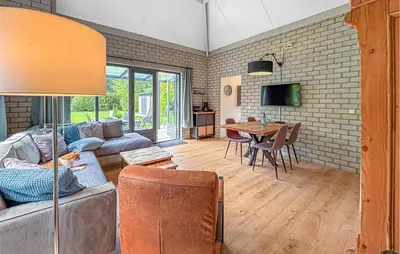 a living room with a couch and a table at Nice Home In Dirkshorn With Wifi in Dirkshorn