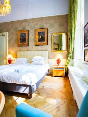 a bedroom with two beds and two mirrors at Boutique Hotel Museumkwartier in Utrecht