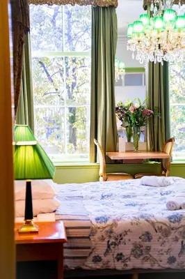 a bedroom with a bed and a table with a lamp at Boutique Hotel Museumkwartier in Utrecht