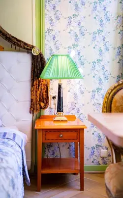 a lamp on a table next to a bed at Boutique Hotel Museumkwartier in Utrecht