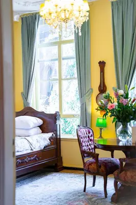 a bedroom with a bed and a table and a window at Boutique Hotel Museumkwartier in Utrecht