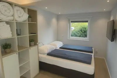 a small room with a bed and a window at Studio Noordwijk in Noordwijk
