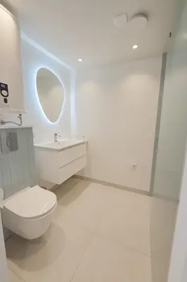a white bathroom with a toilet and a sink at Studio Noordwijk in Noordwijk