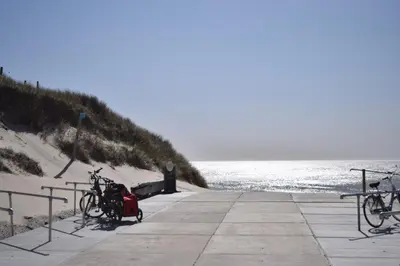 two bikes parked on a pier next to the ocean at Marinus, lovely bungalow near the sea and most beautiful dune area in the Netherlands in Warmenhuizen