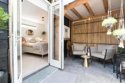 a room with a sliding glass door leading to a bedroom at Ben Thuis Studio Alkmaar in Alkmaar
