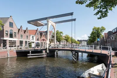 a bridge over a river in a city with buildings at Ben Thuis Studio Alkmaar in Alkmaar