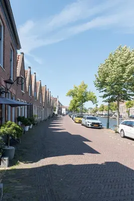 a cobblestone street with cars parked on the side at Ben Thuis Studio Alkmaar in Alkmaar