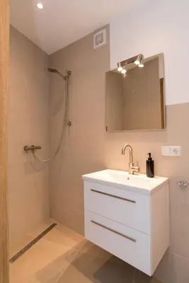 a bathroom with a white sink and a shower at Ben Thuis Studio Alkmaar in Alkmaar