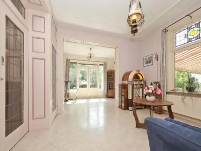 a living room with a blue couch and a table at Characteristic country house with wellness