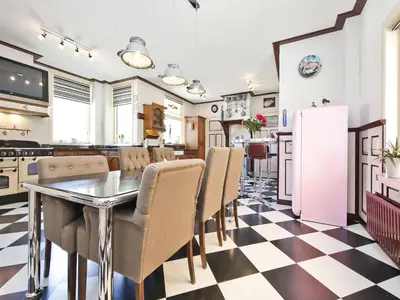 a kitchen and dining room with a table and chairs at Characteristic country house with wellness