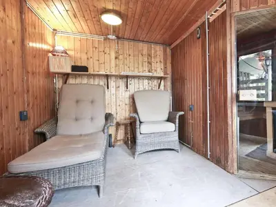 a living room with two chairs and a couch at Characteristic country house with wellness