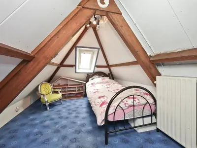 a room with a bed in a attic at Characteristic country house with wellness
