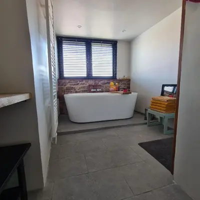 a bathroom with a large white tub and a window at Park 43 in Haarlem