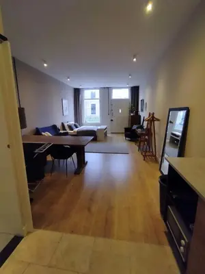 a living room with a table and a couch at Park 43 in Haarlem