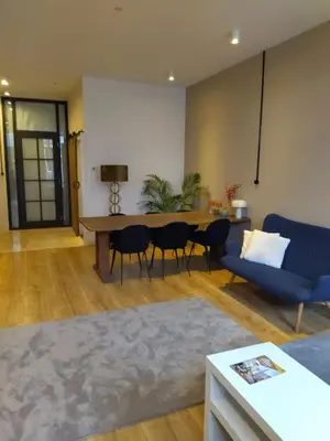 a living room with a blue couch and a table at Park 43 in Haarlem