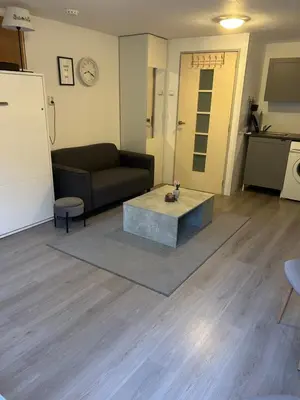 a living room with a couch and a coffee table at Vlinder 2pers studio in Utrecht