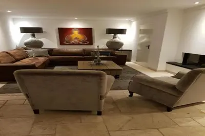 a living room with a couch and a table at Villa in Bosrijk near Horsterwold Forest in Zeewolde