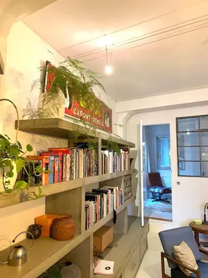 a room with a book shelf filled with books at B&B Loft 57 in Amsterdam