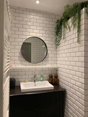 a bathroom with a sink and a mirror at B&B Loft 57 in Amsterdam