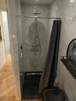 a shower with a shower curtain and a sink at Luxury apartment in the pijp near the Rai in Amsterdam