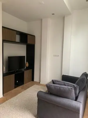 a living room with a couch and a flat screen tv at Luxury apartment in the pijp near the Rai in Amsterdam