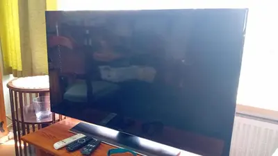 a large flat screen tv sitting on top of a table at classic beach home in Zandvoort