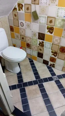 a bathroom with a toilet and a tiled floor at classic beach home in Zandvoort