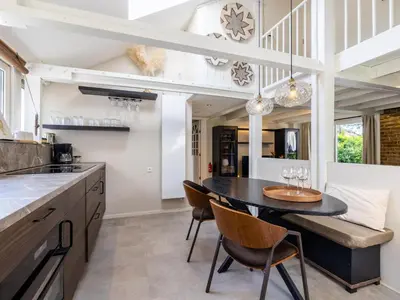 a kitchen with a dining room table and chairs at Rekerlanden 1 in Warmenhuizen