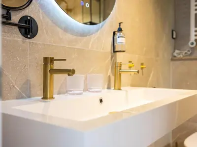 a bathroom with two sinks and a mirror at Rekerlanden 1 in Warmenhuizen