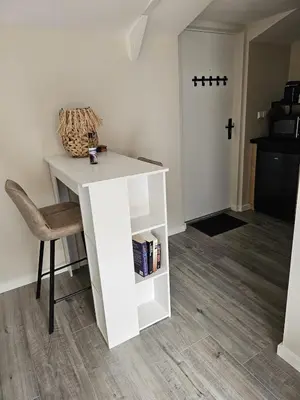 a white desk with a chair and a book shelf at Sandy beach 34 in Noordwijk