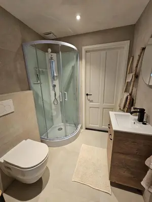 a bathroom with a shower and a toilet and a sink at Sandy beach 34 in Noordwijk