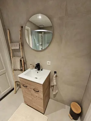 a bathroom with a sink and a mirror at Sandy beach 34 in Noordwijk