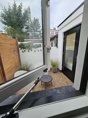 an open door to a patio with a window at Sandy beach 34 in Noordwijk