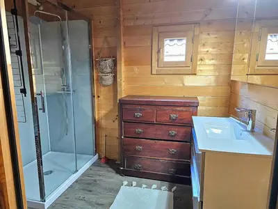 a bathroom with a shower and a sink and a tub at De Fijne Blokhut in Nijkerkerveen