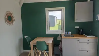 a kitchen with a table and a sink and a window at Recreatie aan de Vecht, Hooibergje 3, Weesp in Weesp