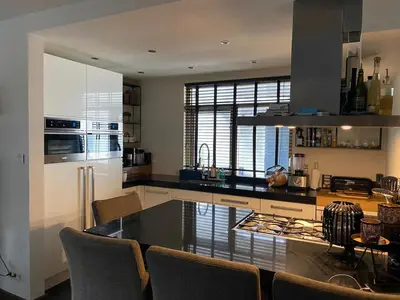 a kitchen with a large island in the middle at Ruime woning met jacuzzi, 10 min van strand in Lisse