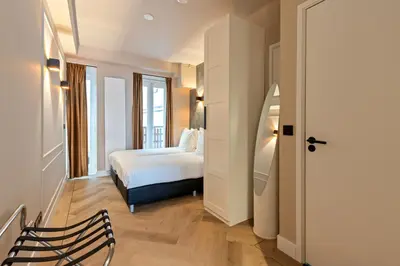 a hotel room with a bed and a window at Midtown Hotel triple in Amsterdam