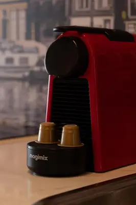 a red toaster sitting on top of a table at Midtown Hotel triple in Amsterdam