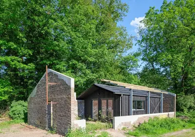 a brick house in the middle of a field at Behouden Huis in Ons Belang
