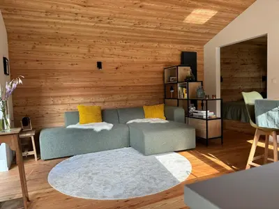a living room with a couch and wooden walls at Behouden Huis in Ons Belang