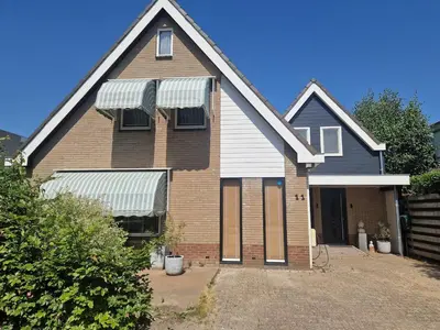 a large brick house with a gambrel at Comfort Apartment Hoofddorp near Amsterdam Schiphol in Hoofddorp