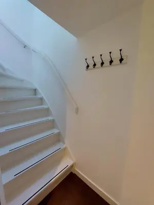 a staircase in a house with white walls and white steps at Comfort Apartment Hoofddorp near Amsterdam Schiphol in Hoofddorp