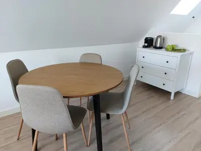 a wooden table with four chairs and a dresser at Comfort Apartment Hoofddorp near Amsterdam Schiphol in Hoofddorp