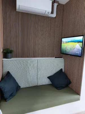 a room with a tv on a wall with two pillows at Comfort Apartment Hoofddorp near Amsterdam Schiphol in Hoofddorp
