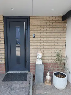 a front door of a brick building with a cat statue at Comfort Apartment Hoofddorp near Amsterdam Schiphol in Hoofddorp