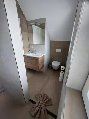 a bathroom with a sink and a toilet and a mirror at Comfort Apartment Hoofddorp near Amsterdam Schiphol in Hoofddorp